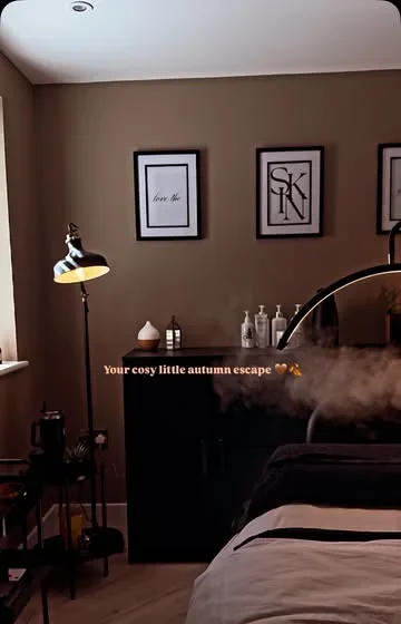 The Skin Retreat treatment room, softly lit with a lamp and warm walls